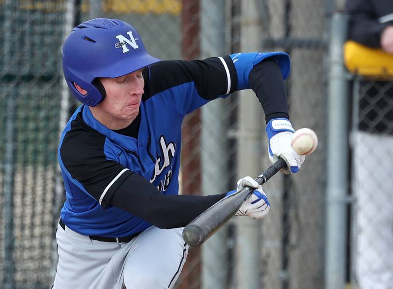 St. Charles North's Henry Grimm tries to get down a bunt during their game against Sycamore Thursday, April 10, 2025, at the Sycamore Park District Sports Complex.
