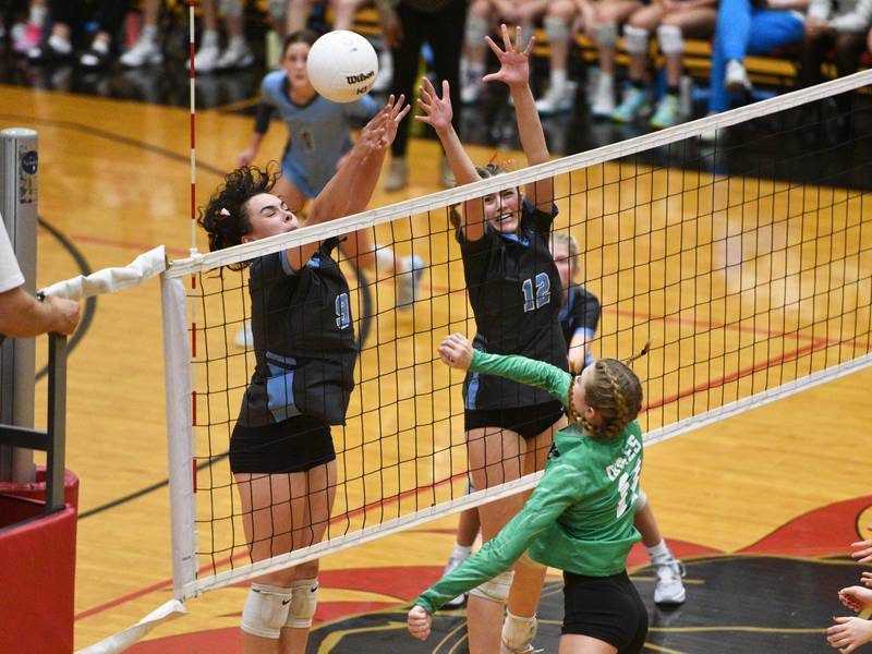 Willowbrook's Calli Kenny (9) and Elle Bruschuk (12) go up for the block against York's Jessie Trapp during Monday's Proviso West Class 4A girls sectional volleyball match in Hillside.