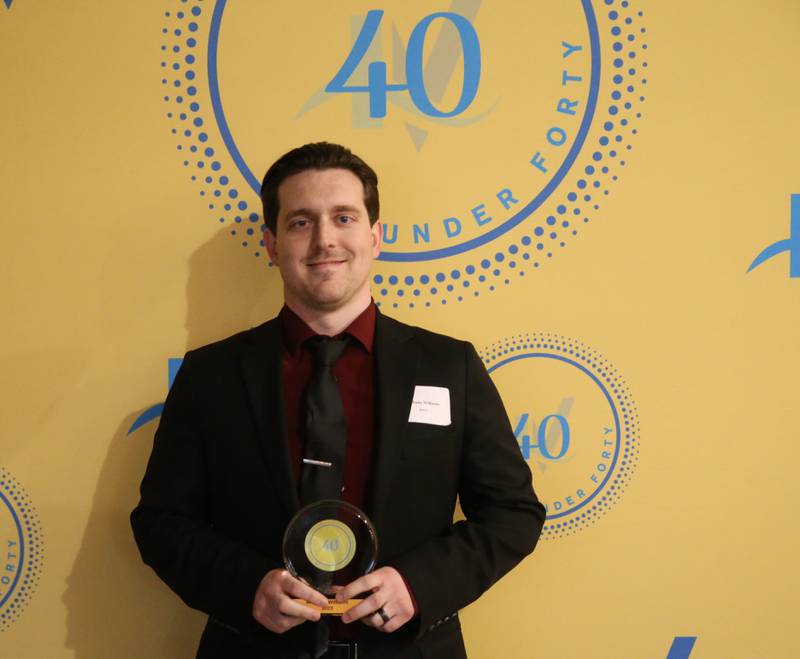 Anthony Williams poses for a photo with his award during the 40 Under Forty awards banquet on Thursday, March 21, 2024 at Westclox in Peru.