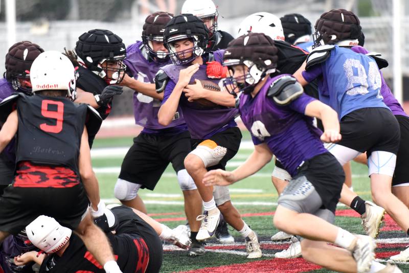 Wilmington's Finn Bryant, center, runs with the ball during a joint summer workout at Bradley-Bourbonnais Wednesday, July 16, 2025.