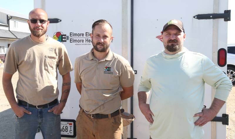 Elemore Electric employees (from left) Sky Abrassart, Dan Elmore and Nolan Drake pose for a photo before leaving for North Carolina on Friday, Oct. 4, 2024 at their shop in Dover. The crews are taking two trucks and two trailers full of equipment and supplies to Hendersonville and Spruce Pine N.C. to assist in the Hurricane Helene relief efforts.