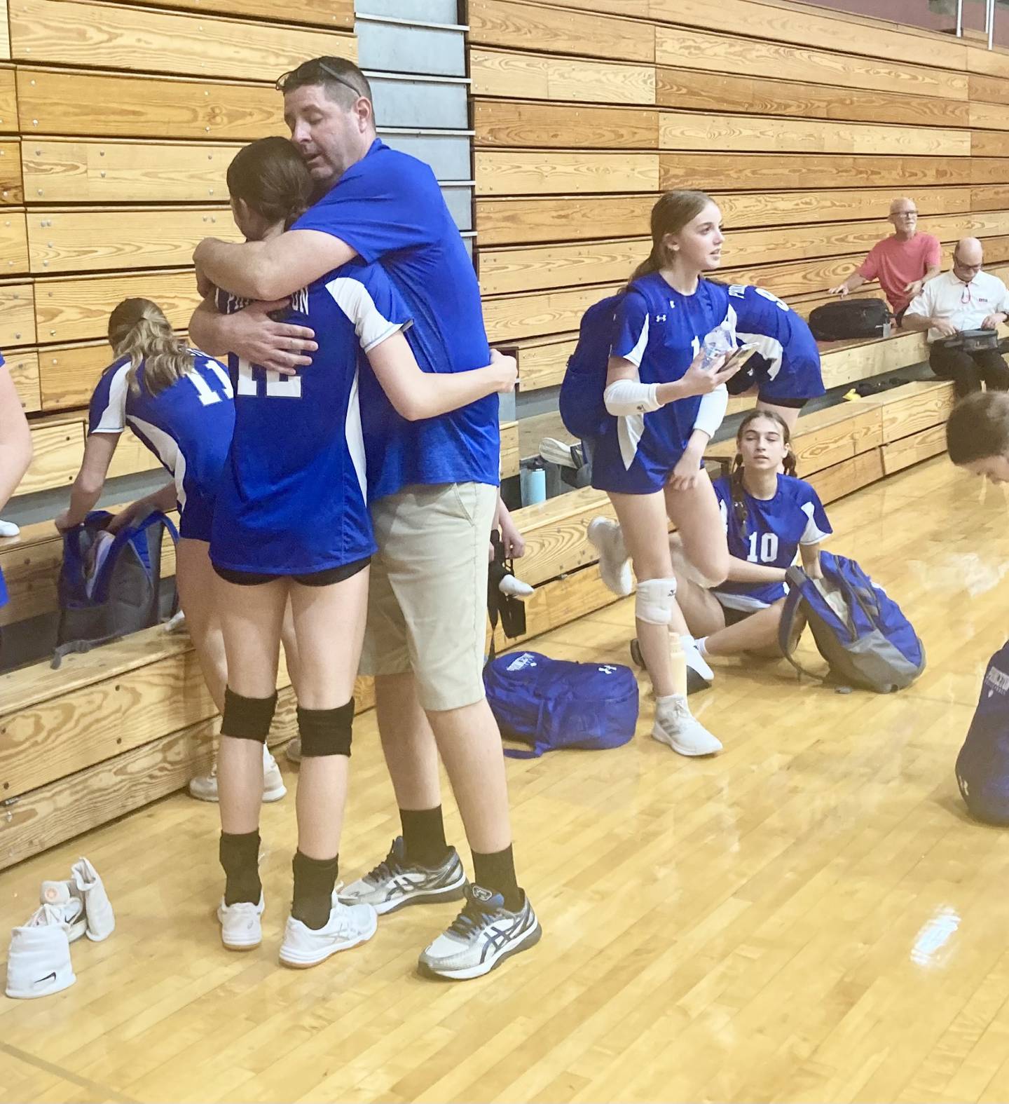 Princeton coach Andy Puck gives senior Chrissy Sierens a hug after their season-ending defeat Tuesday night to El Paso-Gridley in regional play at Chillicothe. The Tigresses bow out with a 16-17-1 record.