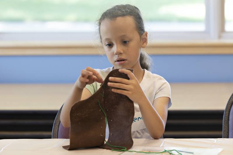 Kendra works on her suturing skills Monday, July 28, 2025, at a veterinary medicine workshop instructed by the Whiteside 4-H at the Rock Falls library.