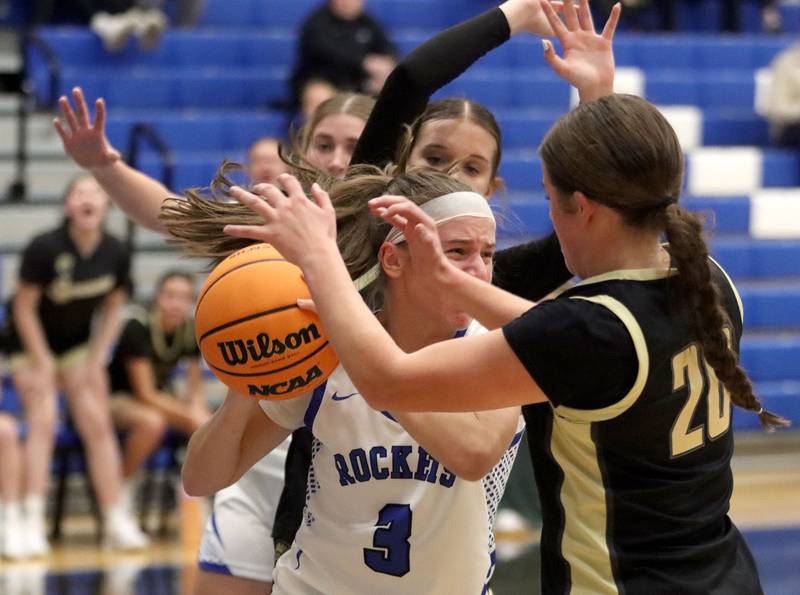 Burlington Central’s Julia Scheuer battles through heavy traffic against Sycamore in girls basketball at Burlington Central High School in Burlington on Tuesday, November 18, 2025.