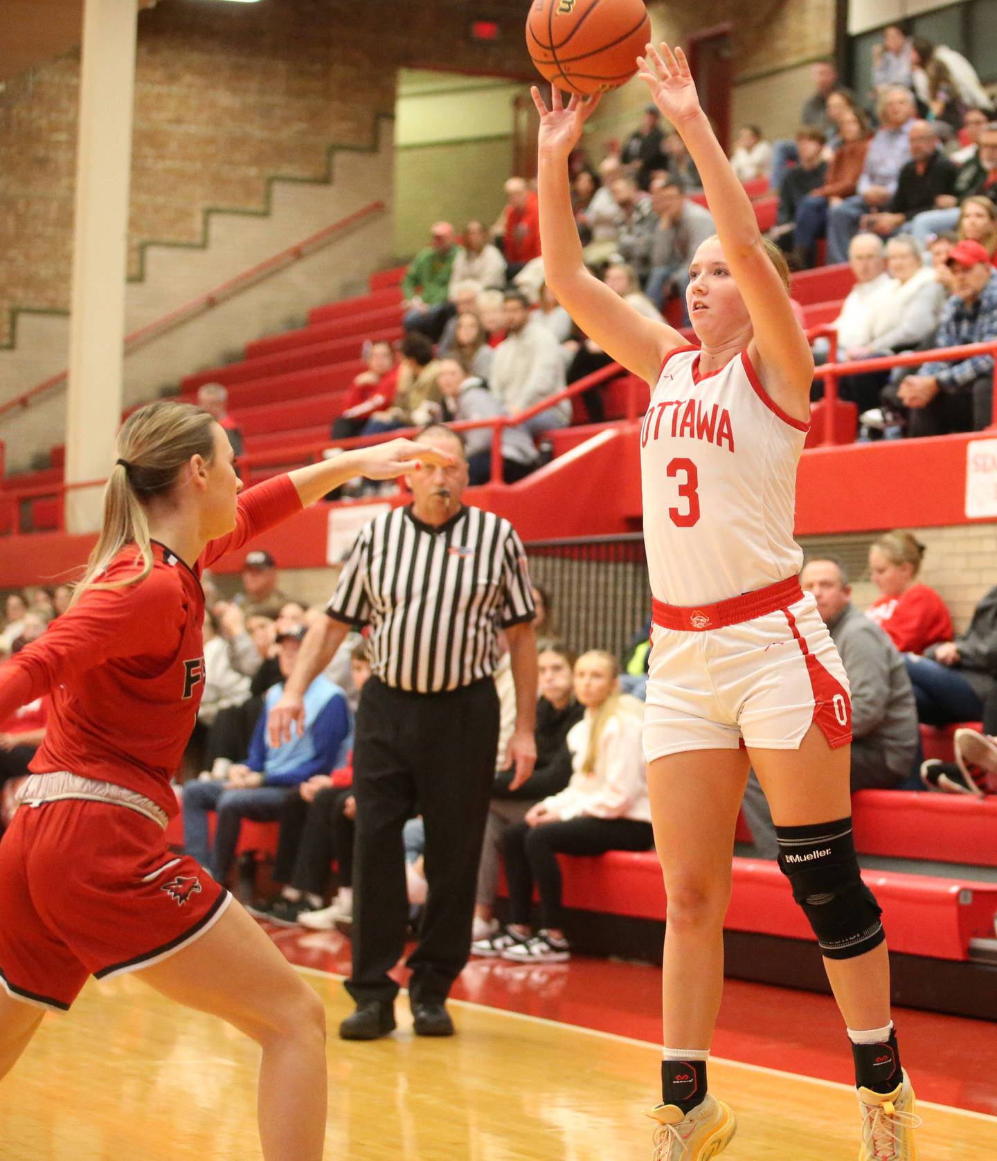 Ottawa's Skylar Dorsey shoots a three-point basket over Yorkville's Bella phillips on Monday, Dec. 4, 2023 at Kingman Gym.