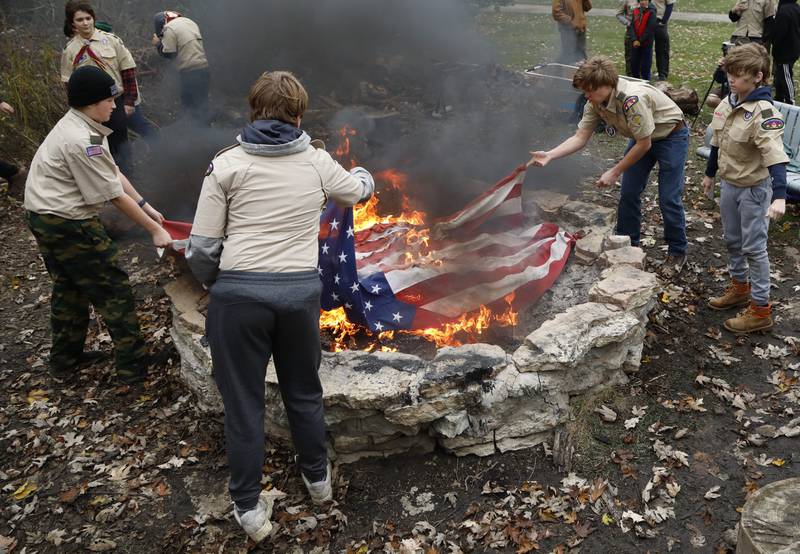 Boy Scouts retire a flag during the Annual Veterans Day Scout VFW vigil and flag retirement ceremony at Overseas VFW Post 1197 in Batavia on Saturday Nov. 5, 2022.