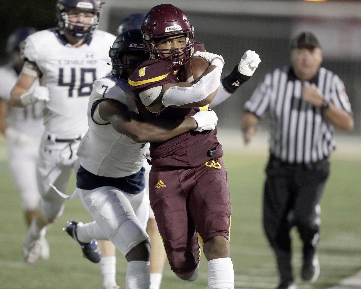 Montini's Josh Robinson (6) tries to slip past IC Catholic Prep's Denzel Gibson (7) during football Friday August 27, 2021 in Lombard.