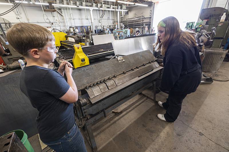 Finn Gainey, 11, of Tampico and Miley Dunkel, 13, of Sterling operate a press brake Thursday, July 13, 2023 in the welding room at WACC. Campers made their own tool box during the welding session.