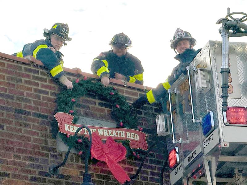 The Mt. Morris Fire Department has strarted its annual Keep the Wreath Red campaign. Pictured here, left to right, are: Bill Howey, Rick Hough, andCapt. Mark Lewis.