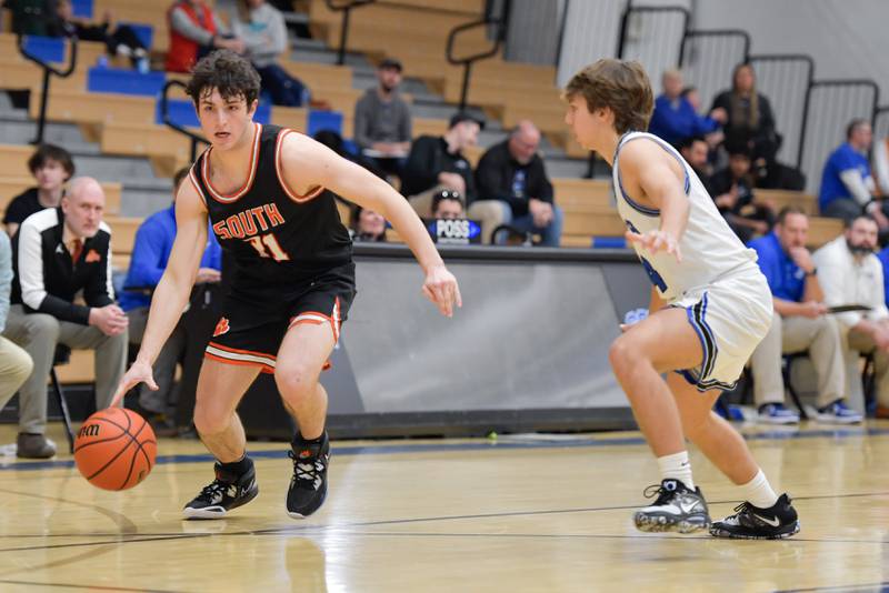 Wheaton Warrenville South Marco Gonzalez (21) moves past St. Charles North's Caden Johnson (4) during a game on Friday, December 2, 2022.