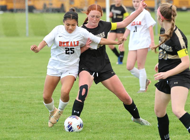 DeKalb's Evelyn Guerra Cruz and Sycamore's Isabelle Segreti collide going after a loose ball Thursday, May 7, 2026, during their game at Sycamore High School.