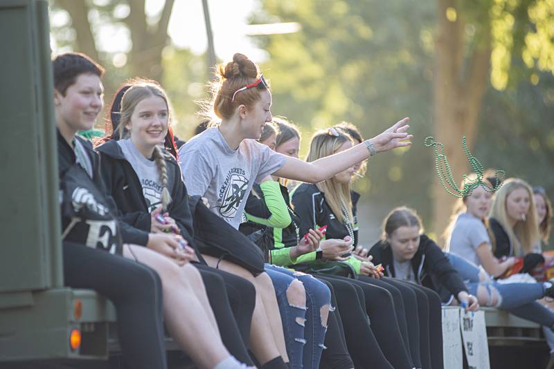 Members of the Rock falls volleyball team fire candy and other treats from their homecoming float Thursday, Sept. 22, 2022.