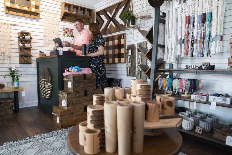 Lumber & Twine owners David and Danielle Badgley, work at last-minute preparations before the opening for business at the grand opening and ribbon cutting of the new McHenry Riverwalk Shoppes in downtown McHenry on Friday, July 21, 2023.