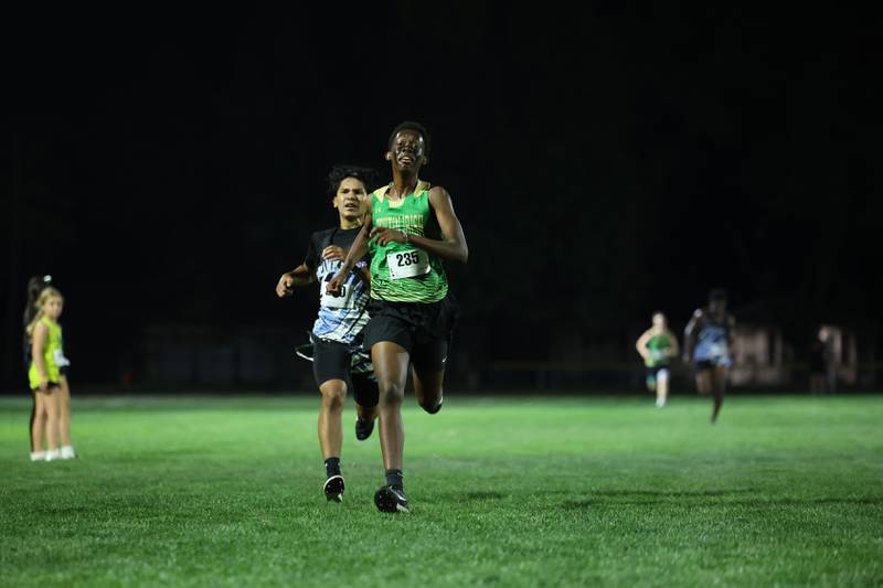 Bishop McNamara's Elijah Muthami nears the finish line ahead of Kankakee's Gael Guzman during the All-City cross country meet at Bishop McNamara on Wednesday, Sept. 17, 2025.