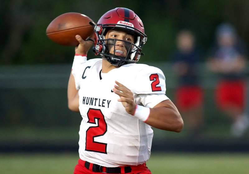 Huntley’s Sam Deligio prepares to unload the ball against Prairie Ridge in football Friday night at Crystal Lake.