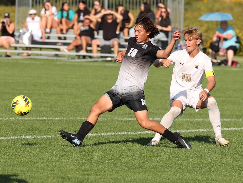 Kaneland's Dylan Pilz (left) kicks the ball away from Sycamore's Gavin Crouch during their game Wednesday, Sept. 16, 2025, at Kaneland High School in Maple Park.