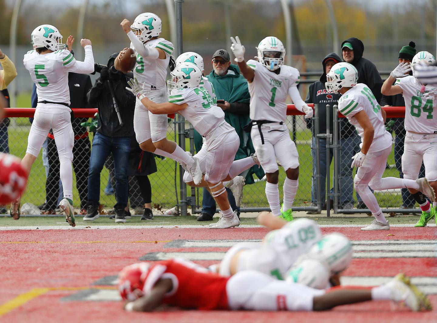 Matt Vezza (9) and the rest of the York team celebrate the winning score during a second round Class 8A varsity football playoff game between York High School and Marist High School on Saturday, Nov. 5, 2022 in Chicago, IL.