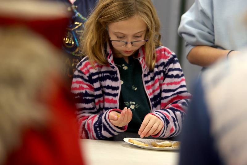 Olivia Schwartz, 7, of Huntley decorates cookies during a Chanukah party at The McHenry County Jewish Congregation Sunday.