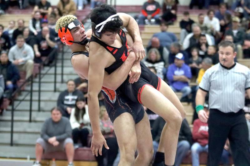 Huntley’s Hersh Suthar (back) battles McHenry’s Armand Paglini at 160 pounds in in their Fox Valley Conference dual on Friday in Huntley.