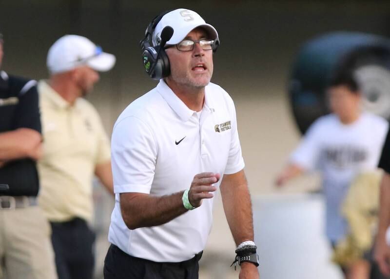 Sycamore head coach Joe Ryan calls in a play during the First National Challenge game Friday, Aug. 25, 2023, in Huskie Stadium at Northern Illinois University in DeKalb.