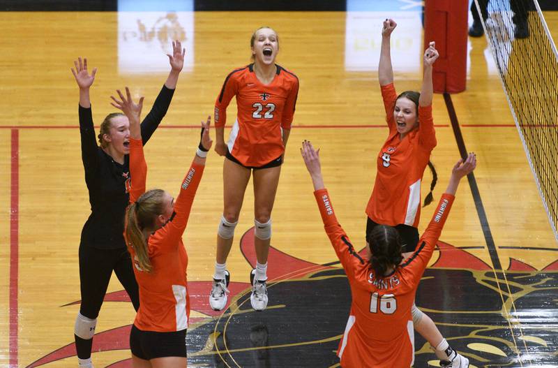 Paul Valade/pvalade@dailyherald.com
St. Charles East's Lia Schneider (1) Alexis Crossen (22) and Natalee Rush (9) celebrate their first-game vistory over Glenbard West during Monday’s Proviso West Class 4A girls seactional volleyball match in Hillside.