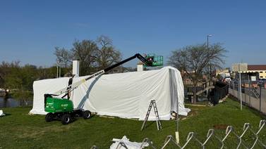 Geneva blacksmith shop shrink-wrap flap persists; city cites developer over plastic cover