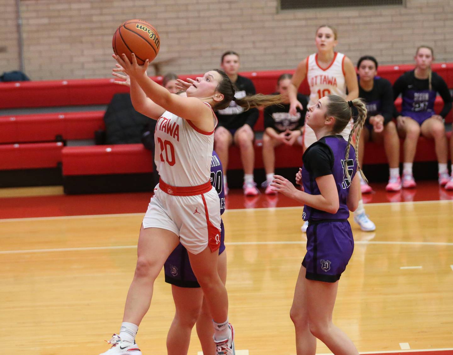 Ottawa's Kendall Lowery sprints to the hoop as Dixon defenders Nora Fordham and Morgan Hargrave arrive late to the play on Wednesday, Nov. 29, 2023 at Kingman Gym.