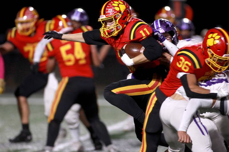 Batavia’s Brett Berggren leaps over a defender while carrying the ball during a Class 7A first-round game against Collinsville on Friday, Nov. 1, 2024 in Batavia.