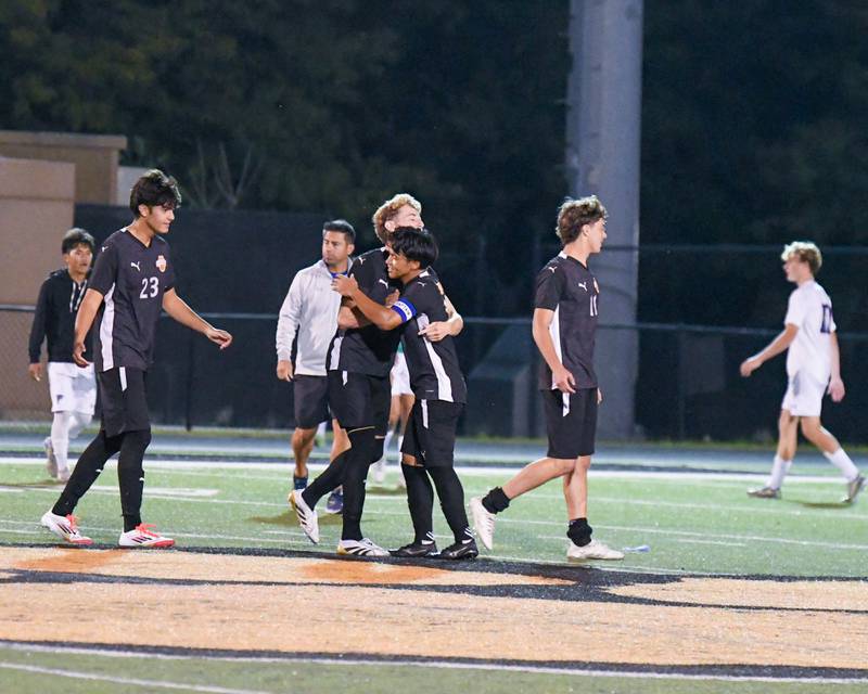 Wheaton Warrenville South Am Za Lian, right, hugs his teammate Joaqujin Martinez after taking the victory over Wheaton North on Thursday Sept. 11, 2025, held at Wheaton Warrenville South.