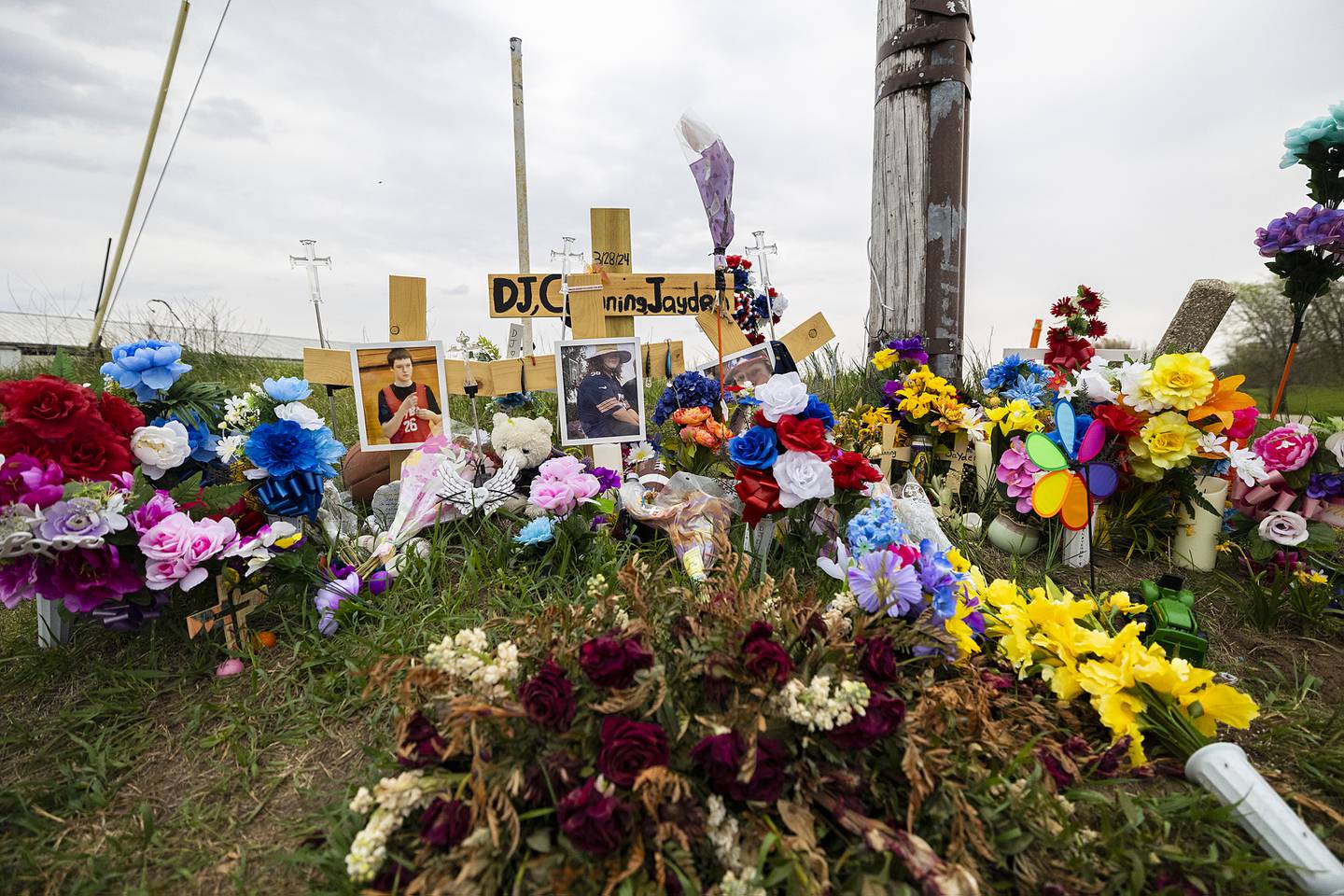 A memorial to accident victims Jayden Lee Hanson and Channing Swertfeger, both 14, and 16-year-old Douglas “DJ” Dorathy  continues to grow Tuesday, April 16, 2024 at the intersection of Luther and Hahnaman Roads in rural Whiteside County.