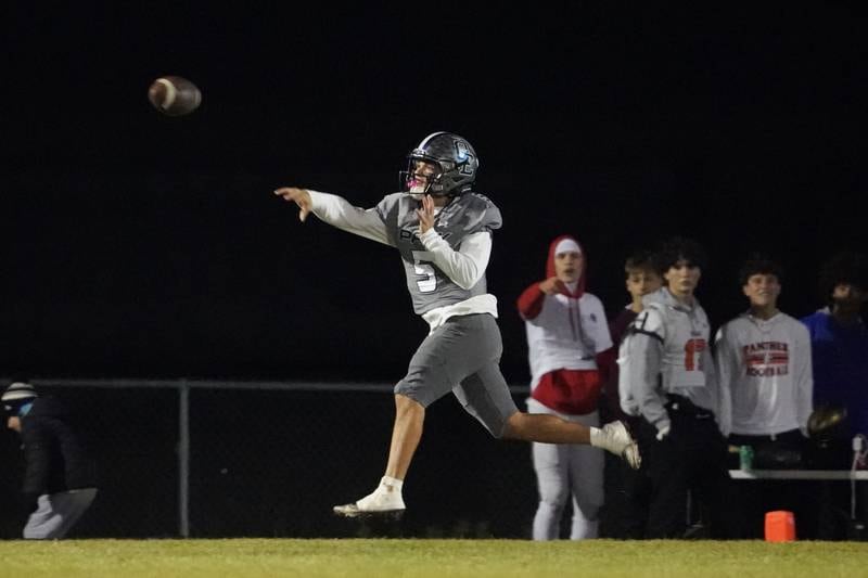 Oswego East's Niko Villacci (5) throws a pass during a football game against Oswego at Oswego East High School on Friday, October 25, 2024.