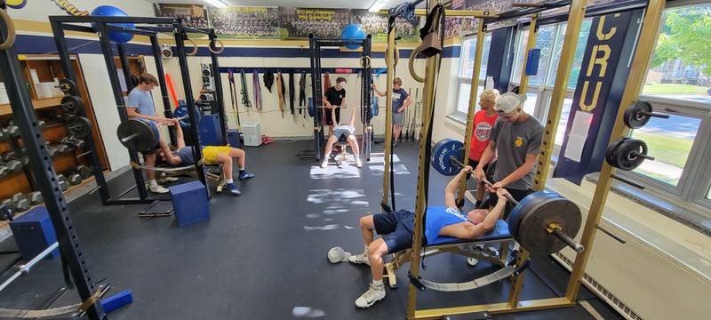Members of the Marquette Academy football team get some of their summer lifting in on Monday, June 27, 2022.