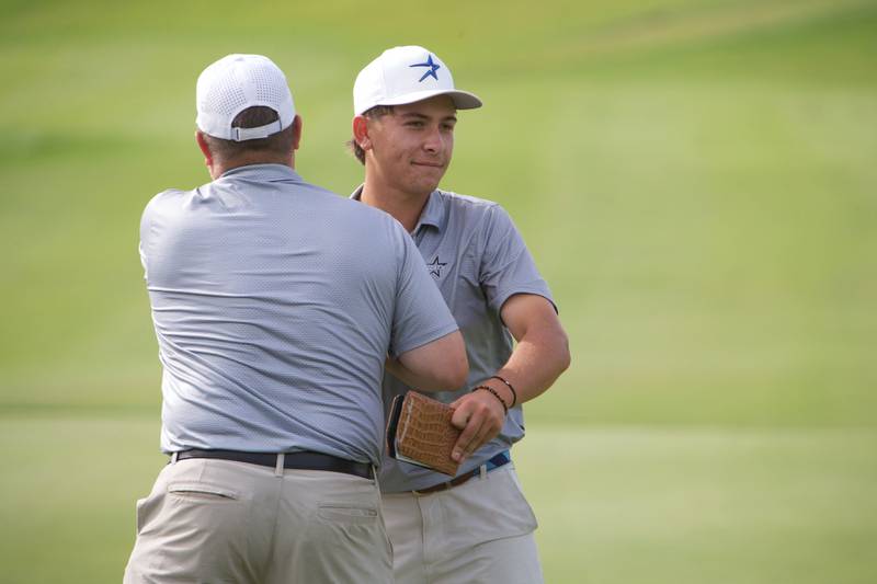 St. Charles North's Jack Van Laningham is congraduated by his Coach on the 18th hole at the Class 3A St. Charles North Regional on Wednesday, Oct. 1, 2025 at Bowes Creek Country Club in Elgin.