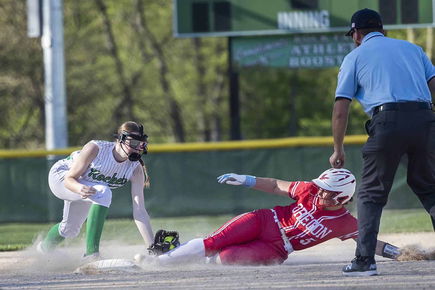 Oregon’s Brooke Halverson slides in safe at third against Rock Falls’ Rylee McFadden Wednesday, April 22, 2026.