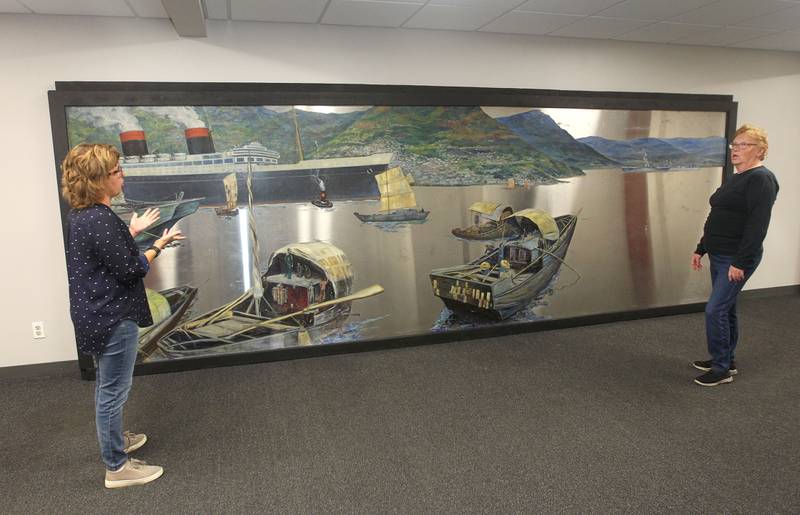Candace H. Johnson for Shaw Local News Network
Amy Whitis, interim Parks & Recreation manager, talks with Nancy Kleszynski, of Woodstock about the Buell Mullen mural on display at the Lakefront Park building in Fox Lake.The mural titled, "Hong Kong," features a view of the Hong Kong harbor and is on loan from the National Museum of the American Sailor. It is approximately 20 ft. long and six-feet high on stainless steel and weighs about 600 pounds. This is one of a two pieces in a mural set with the other piece on display at the County Building in downtown Waukegan. (10/31/22)