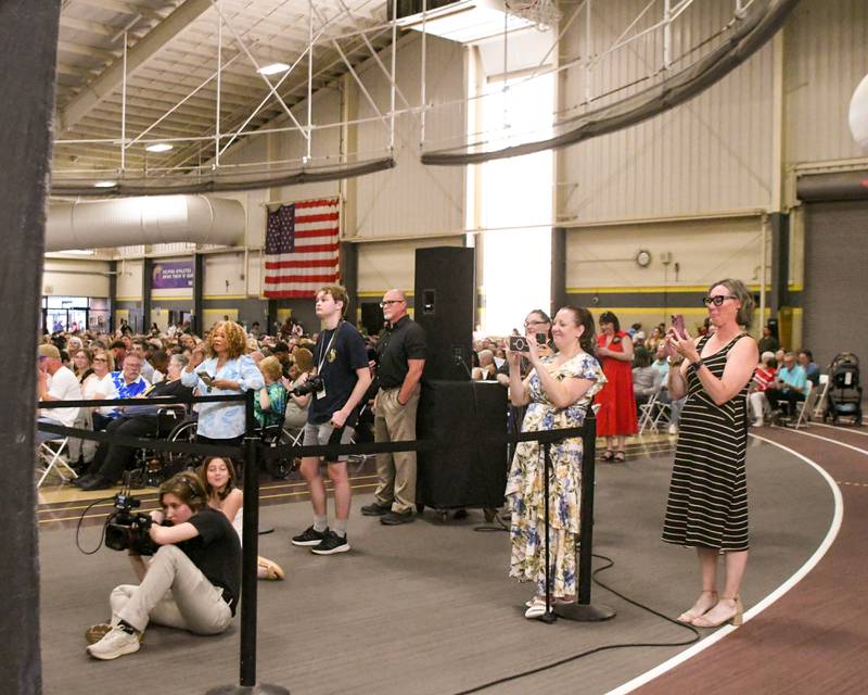 Some graduation attendees try to get a good photo of their graduate after they cross the stage to receive their diploma on Sunday May 24, 2026, held at Sycamore High School.