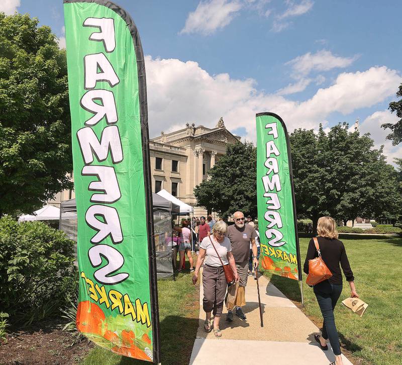 Patrons visit the Sycamore Farmers Market Tuesday, June 7, 2022, at its new location on the lawn of the DeKalb County Courthouse.