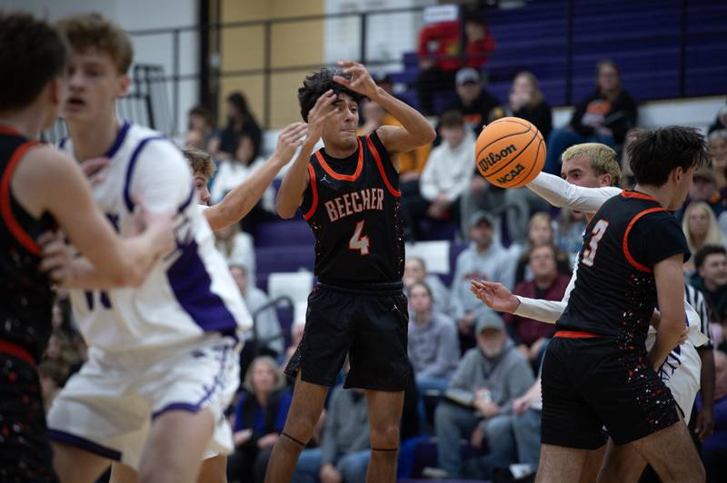 Beecher's Wences Baumgartner, center, loses the ball while in the lane against Manteno in the Thanksgiving tournament at Manteno High School on Monday, November 24, 2025.
