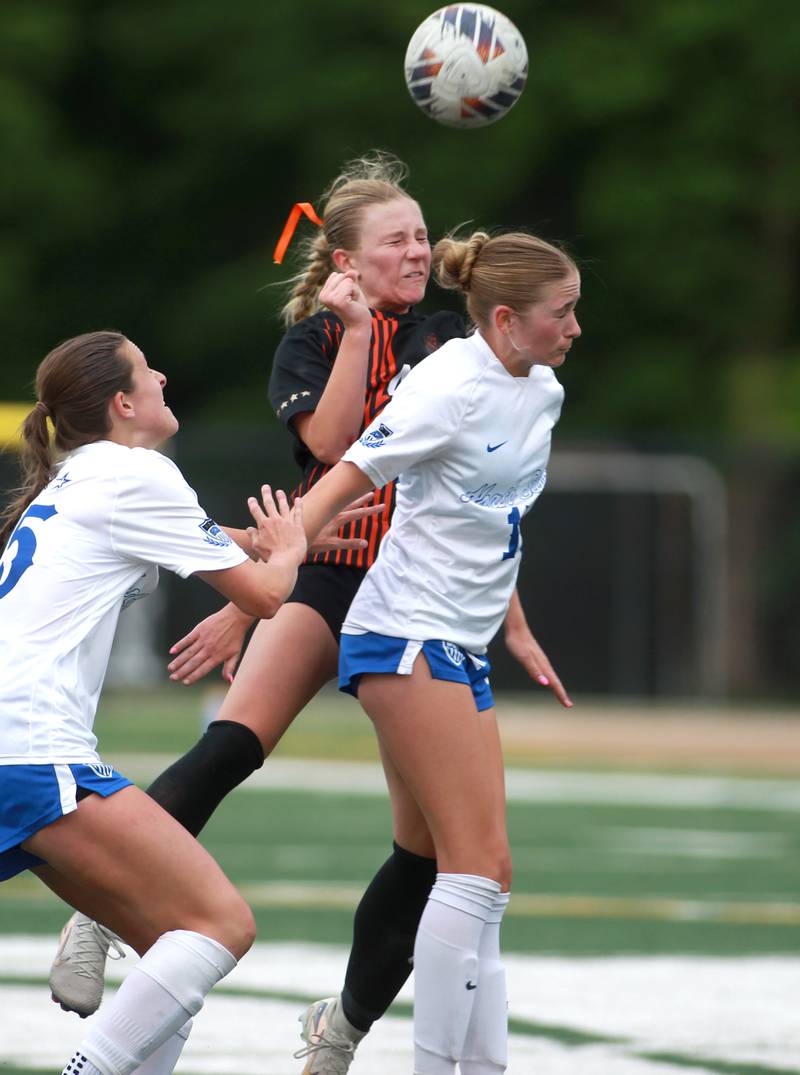 St. Charles East's Presley Kannaka and St. Charles North's Keira Connolly head the ball during a Class 3A Glenbard West Sectional semifinal game on Tuesday, May 27, 2025 in Glen Ellyn.