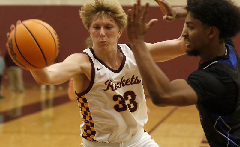 Richmond-Burton's Luke Robinson tries to see the ball from going out of bounds in front of Woodstock's Anthony Grzetic during a Kishwaukee River Conference basketball game on Wednesday, Feb. 5, 2025, at Richmond-Burton High School.