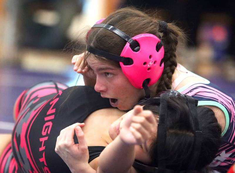 Woodstock’s Eva Hermansson, top, battles Kaneland’s Amdahy Torres at 105 pounds in Whip-Pur Women’s Classic varsity girls wrestling on Saturday, Dec. 20, 2025, at Hampshire High School in Hampshire.