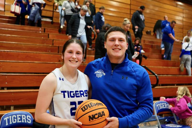 Princeton senior Camryn Driscoll became the sixth 1,000-point scorer in program history, scoring 17 points in Monday's 54-17 win over Henry-Senachwine at Prouty Gym. She marks the moment with her brother, Evan.