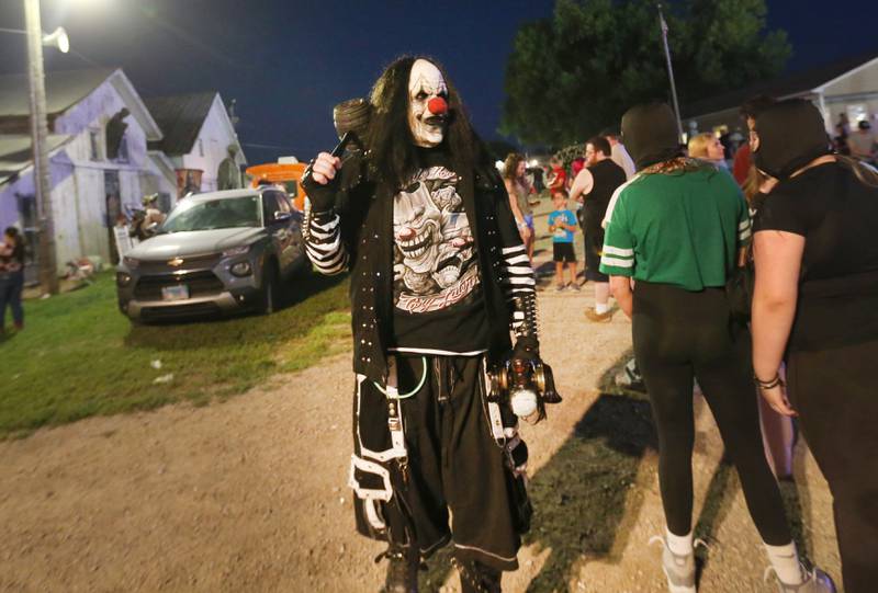A character from Nightmare on Fairgrounds Road walks through a line of visitors during the 170th annual Bureau County Fair on Saturday, Aug. 23, 2025 in Princeton. The haunted attraction offered a preview of their 2025 season.