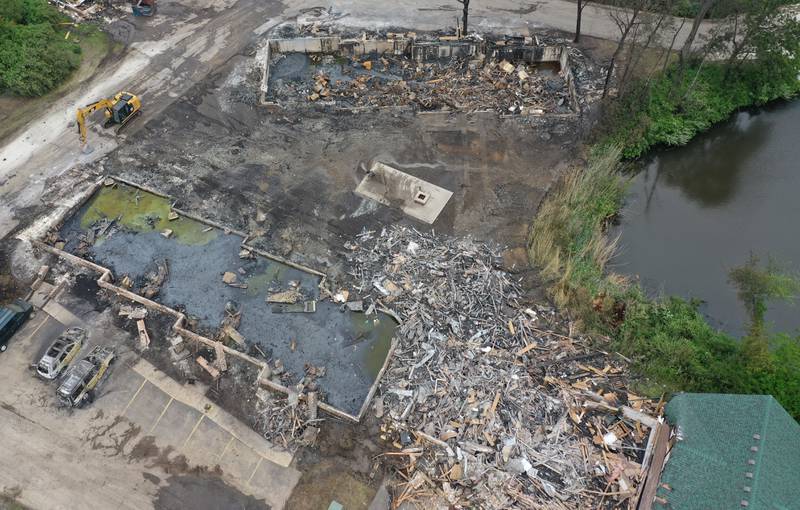Chard vehicles, foundations and burnt trees are all that remains from a major fire that leveled 28 cabins at Grand Bear Resort on Tuesday, May 31, 2022 in Utica.