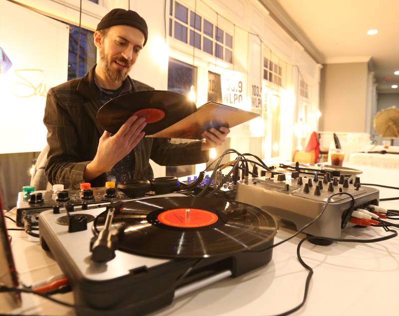 Local musician Kevin Kramer of La Salle plays vinyl records during the WLPO 75th Anniversary party on Wednesday, Nov. 16, 2022 at Senicas Oak Ridge in La Salle.