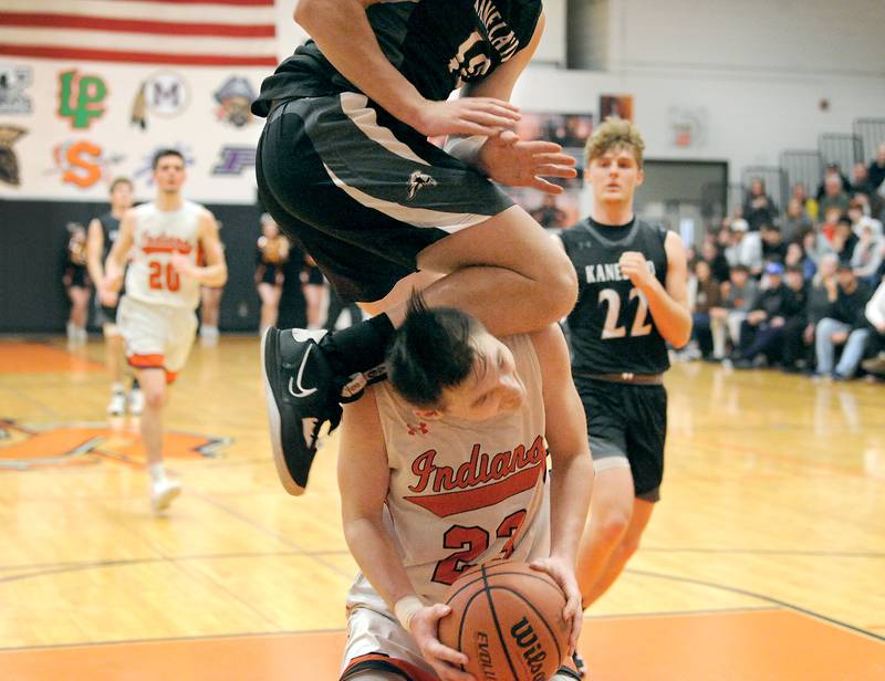 Sandwich's Chance Lange (23) takes tough foul from Kaneland defender Troyer Carlson (10) during a boys' basketball game at Sandwich High School on Friday, Jan. 13, 2023.
