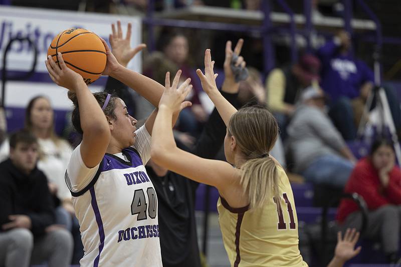 Dixon's Hallie Williamson looks to pass while being guarded by Morris’ Alyssa Jepson Friday, Jan. 3, 2025, at Dixon High School.