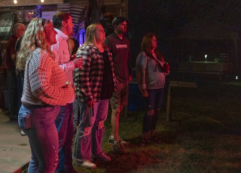 A group of friends listen to the Walton Fest closing band “abbynormal” Saturday, Sept. 20, 2025. Music, food, drinks and four musical acts were all on tap at the tiny town’s big festival.
