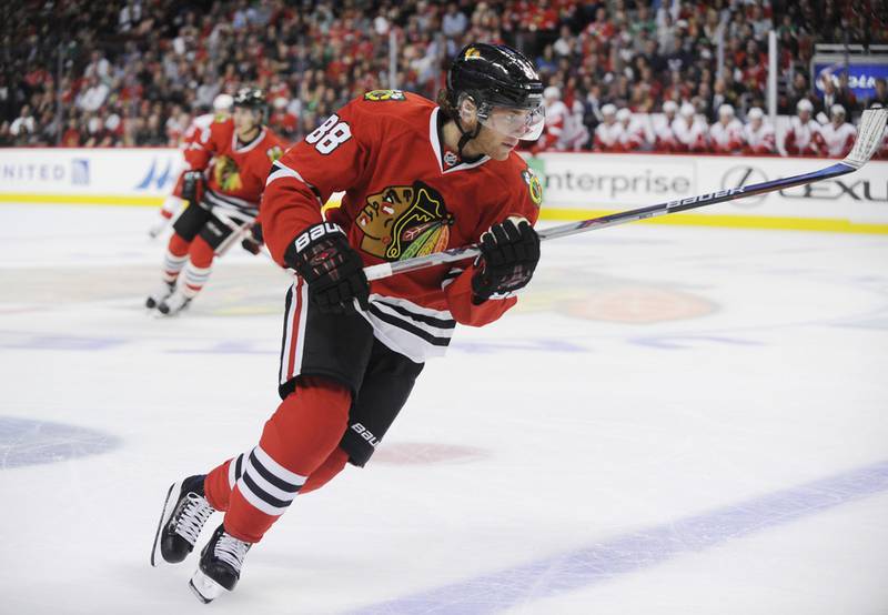 Chicago Blackhawks right wing Patrick Kane (88) chases the puck against the Detroit Red Wings in the first period of their pre-season NHL hockey game in Chicago, Tuesday, Sept. 22, 2015.  (AP Photo/David Banks)