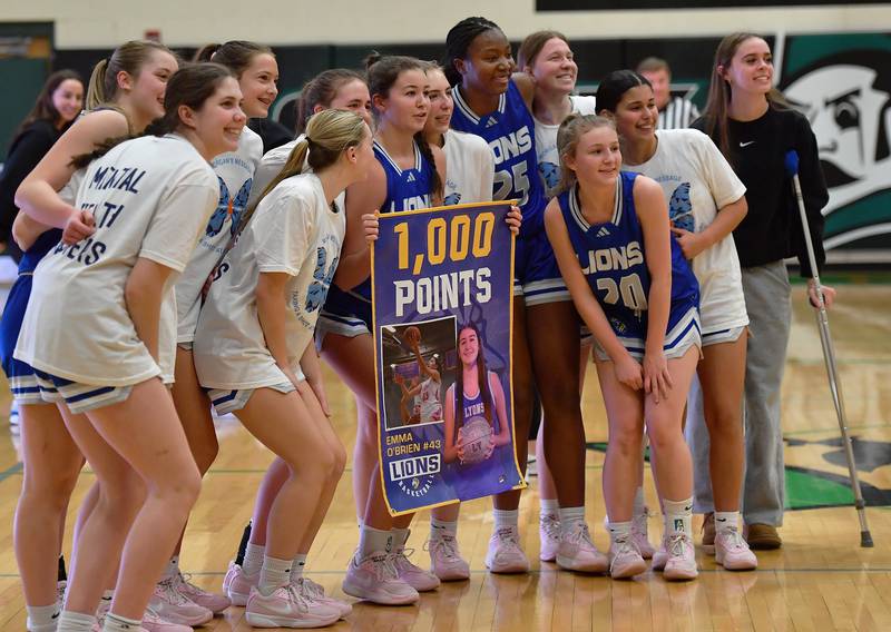 Lyons Township’s Emma O’Brien holds a poster commemorating her 1000th points during a game on February 4, 2025 at York High School in Elmhurst.